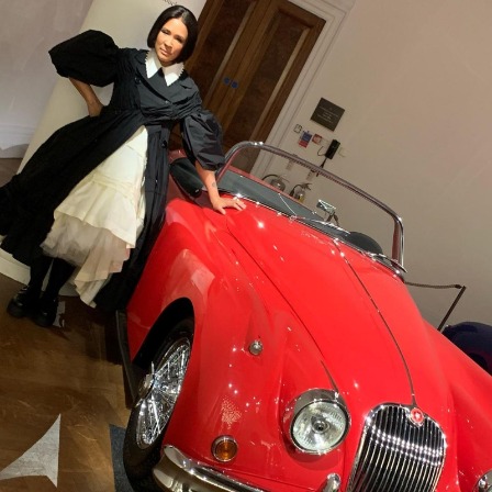 Golda Rosheuvel with a luxurious car at Queens Jubilee celebration.